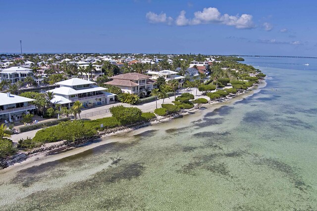 drone / aerial view featuring a view of the beach and a water view