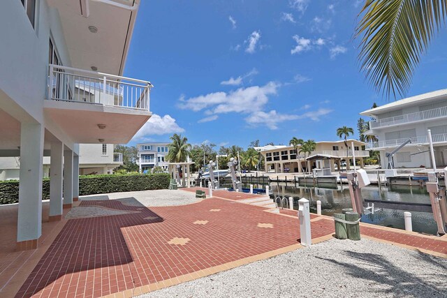 exterior space with a water view and a boat dock