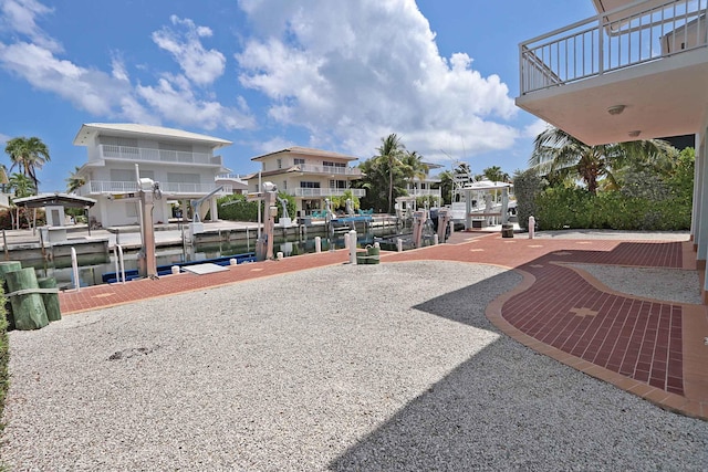 view of property's community with a water view and a boat dock