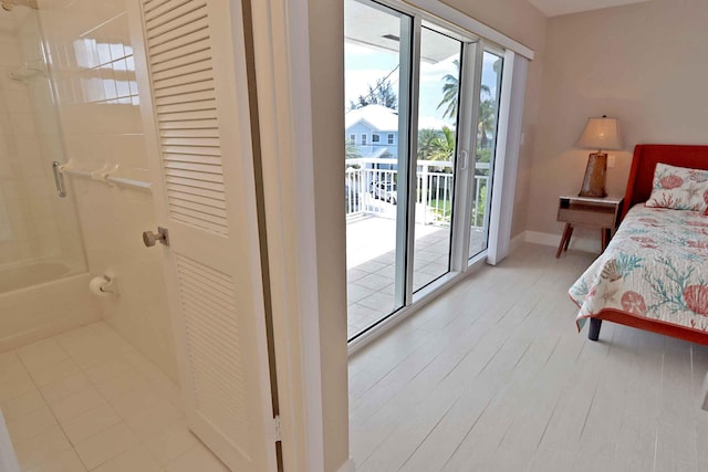 bedroom with light wood-type flooring and access to outside