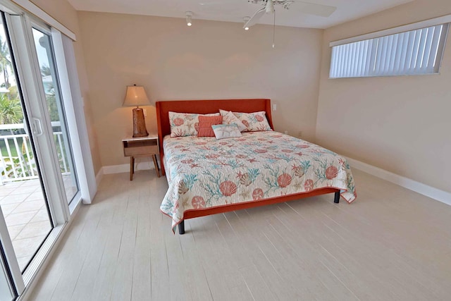 bedroom with ceiling fan, access to exterior, and light wood-type flooring