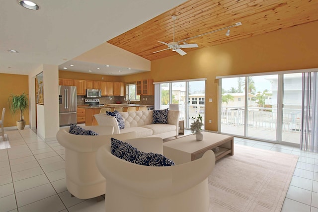 tiled living room featuring lofted ceiling, sink, wood ceiling, and ceiling fan