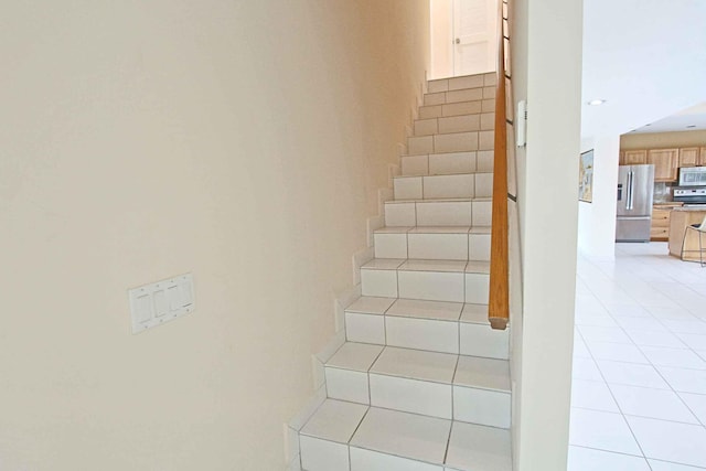 stairs with tile patterned floors