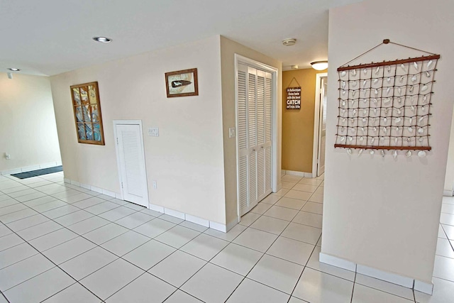 corridor with light tile patterned floors