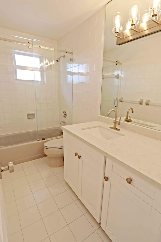 full bathroom with toilet, vanity, shower / bath combination with glass door, and tile patterned flooring