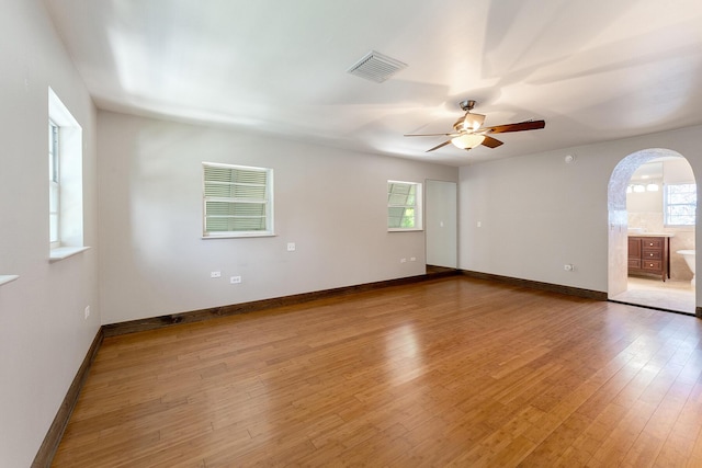 empty room with hardwood / wood-style flooring and ceiling fan