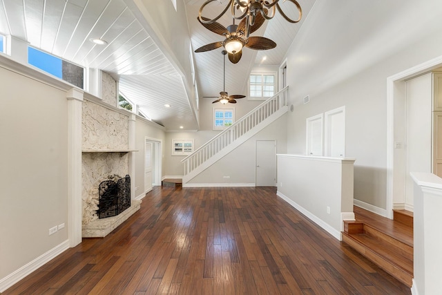 unfurnished living room featuring dark hardwood / wood-style flooring, a fireplace, high vaulted ceiling, and wooden ceiling