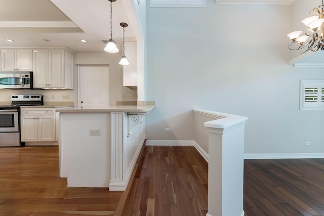 kitchen with dark hardwood / wood-style flooring, pendant lighting, stainless steel appliances, and white cabinets