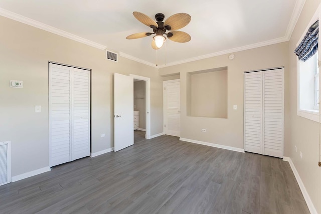 unfurnished bedroom with crown molding, dark hardwood / wood-style floors, and a closet