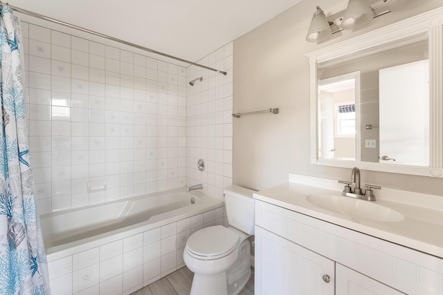 full bathroom with vanity, shower / bath combo, and toilet