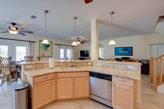 kitchen with sink, light brown cabinetry, decorative light fixtures, stainless steel dishwasher, and french doors