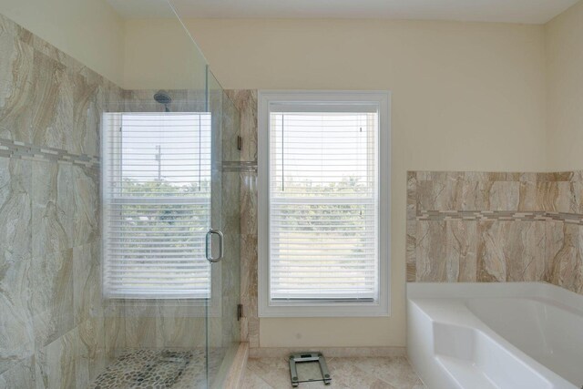 bathroom featuring separate shower and tub