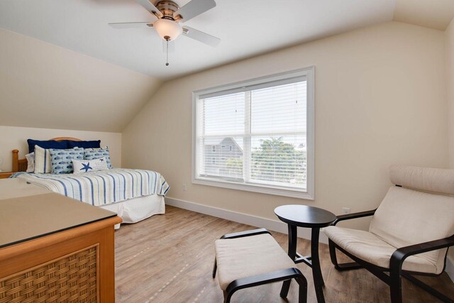 bedroom featuring ceiling fan, lofted ceiling, and light wood-type flooring