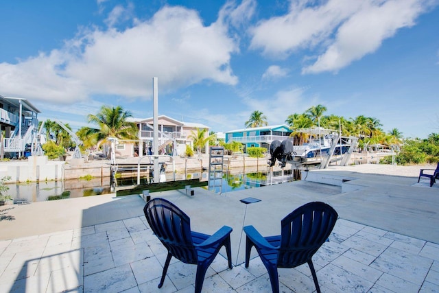 view of patio featuring a boat dock and a water view