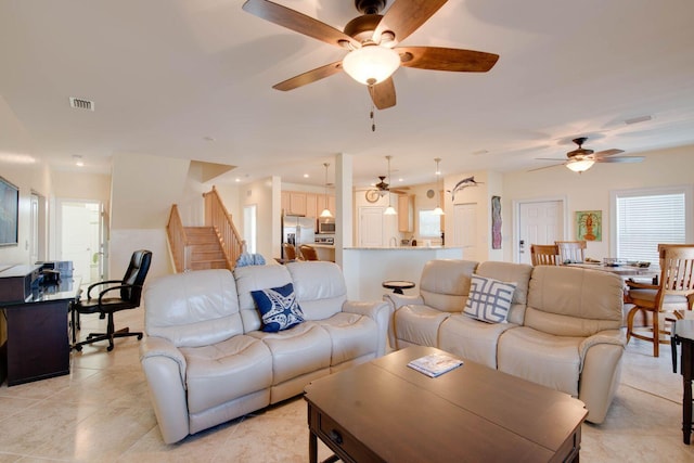 living room featuring ceiling fan and light tile patterned flooring