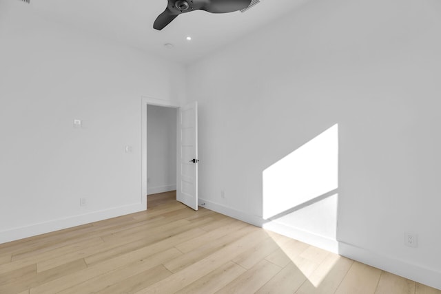 spare room with visible vents, ceiling fan, baseboards, and wood finished floors