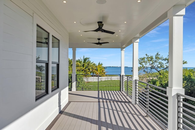 deck featuring a water view and a ceiling fan