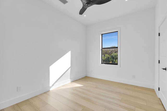 spare room featuring ceiling fan, baseboards, and wood finished floors