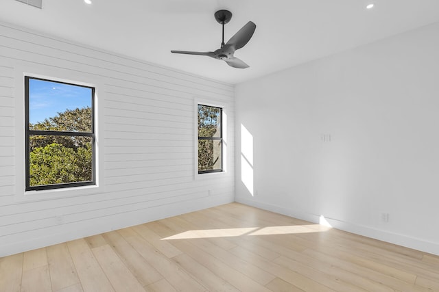 unfurnished room with a ceiling fan, a wealth of natural light, recessed lighting, and wood finished floors