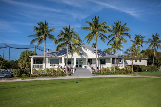 view of front of property with a porch and a front lawn