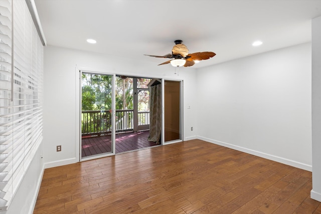 empty room with ceiling fan and wood-type flooring