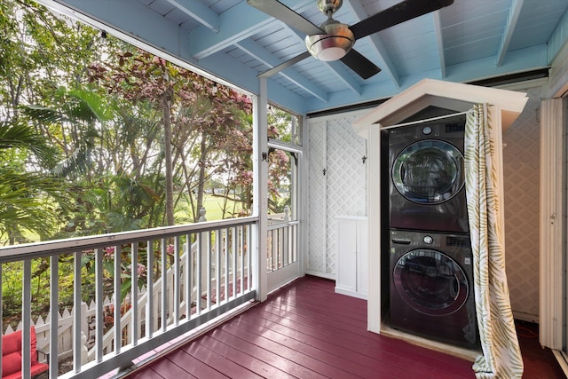 wooden terrace featuring ceiling fan and stacked washing maching and dryer