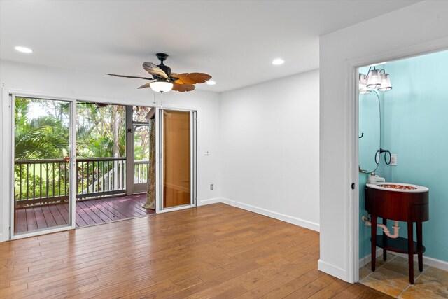 unfurnished room with hardwood / wood-style floors and ceiling fan