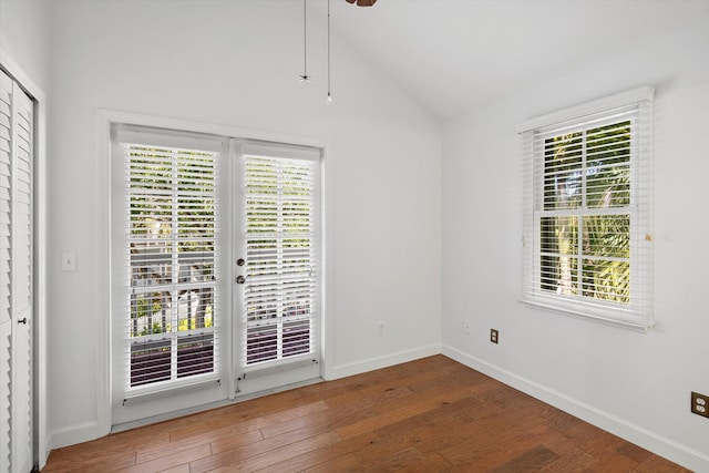 empty room featuring dark hardwood / wood-style flooring and vaulted ceiling