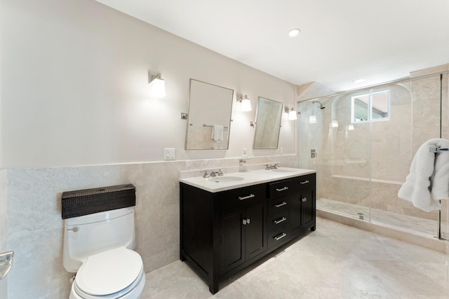 bathroom with vanity, toilet, tile walls, and walk in shower