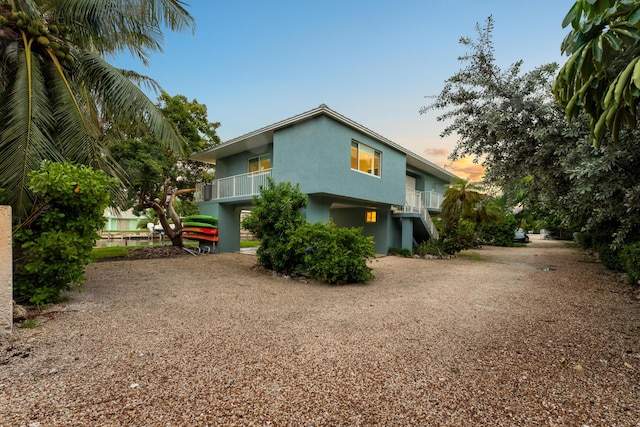 property exterior at dusk with a balcony