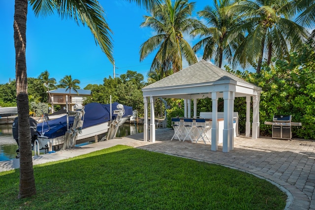 view of yard featuring a water view, a dock, an outdoor bar, and a gazebo