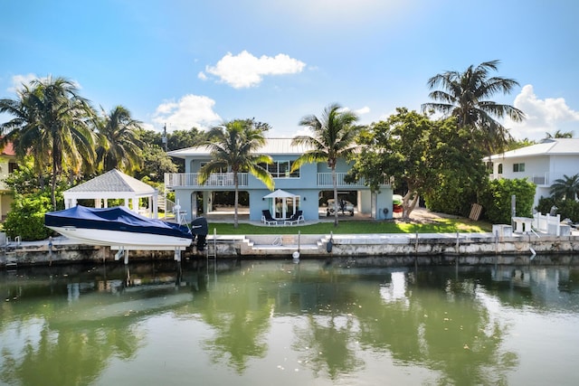 dock area with a balcony and a water view