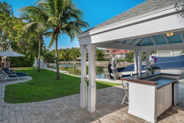 view of patio / terrace featuring a gazebo, a water view, a dock, and a bar