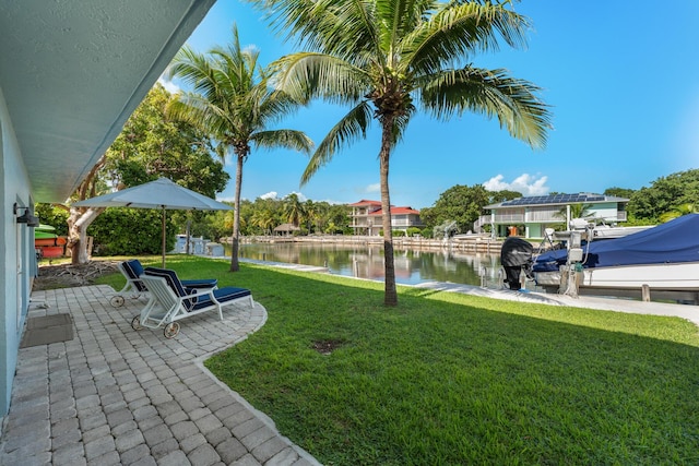 view of yard with a boat dock and a water view