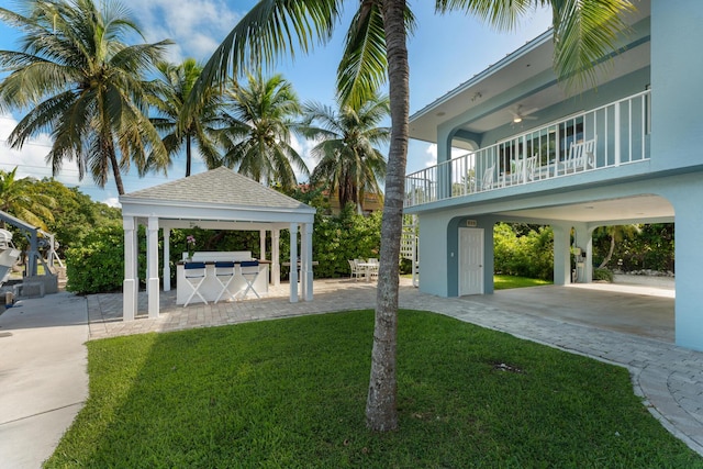 surrounding community with an outdoor kitchen, a yard, and a patio