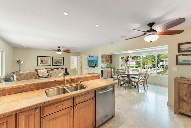 kitchen with light stone countertops, sink, stainless steel dishwasher, and ceiling fan