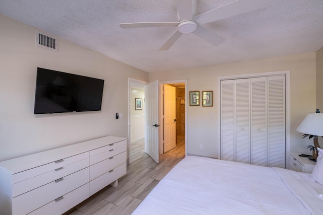 bedroom with ceiling fan, a closet, and a textured ceiling