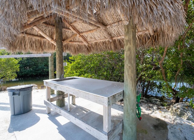 view of patio / terrace featuring a gazebo and a water view