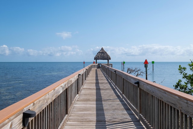 view of dock with a gazebo and a water view