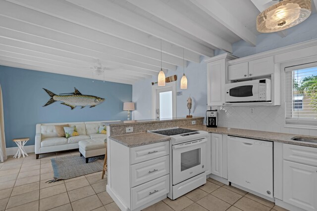 kitchen with white appliances, kitchen peninsula, and white cabinets