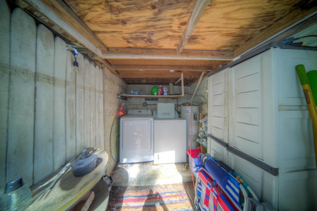 basement featuring water heater and washer and dryer