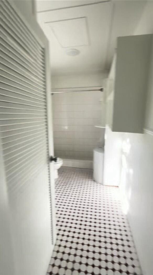 bathroom with tile patterned flooring and a shower