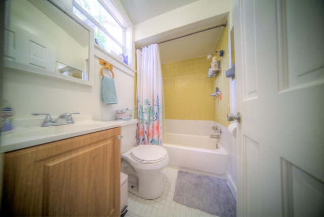 full bathroom with vanity, shower / tub combo with curtain, tile patterned floors, and toilet