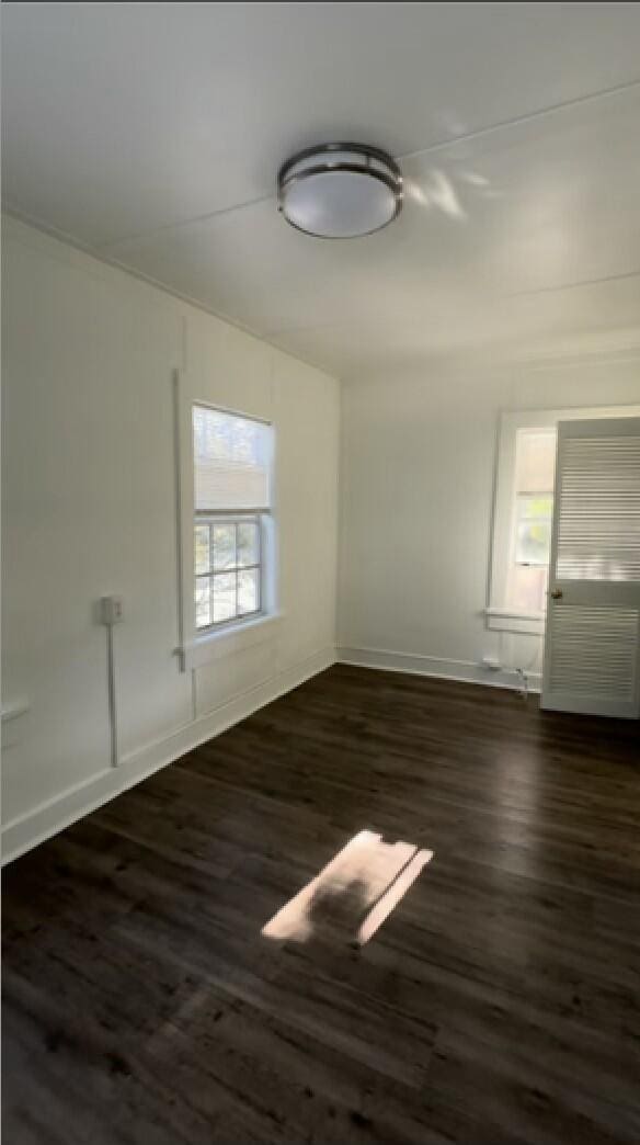 spare room featuring dark hardwood / wood-style flooring