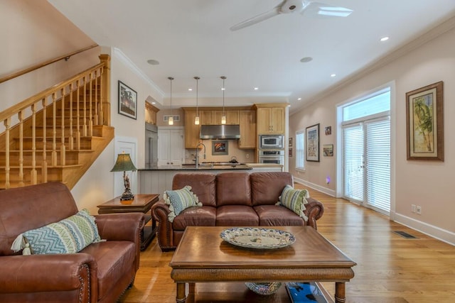 810 Terry Ln, Key West, FL 33040 - living room featuring stairs, crown molding, light wood-type flooring, ceiling fan, and recessed lighting
