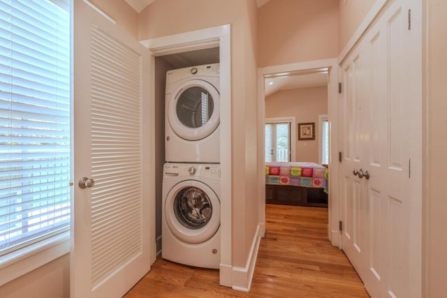 810 Terry Ln, Key West, FL 33040 - laundry room featuring stacked washing machine and dryer and light wood-style floors
