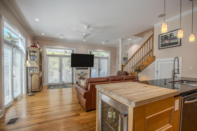810 Terry Ln, Key West, FL 33040 - kitchen featuring beverage cooler, butcher block counters, light wood-type flooring, ceiling fan, and stainless steel dishwasher