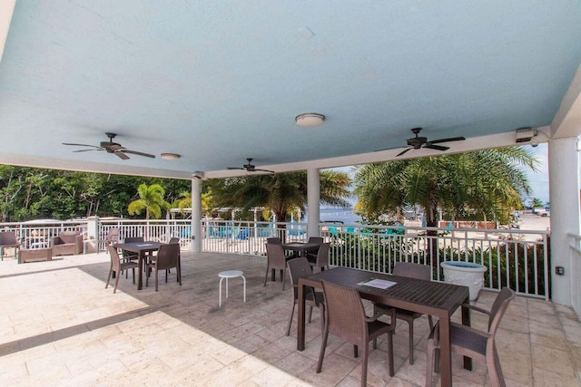 view of patio featuring a community pool and ceiling fan