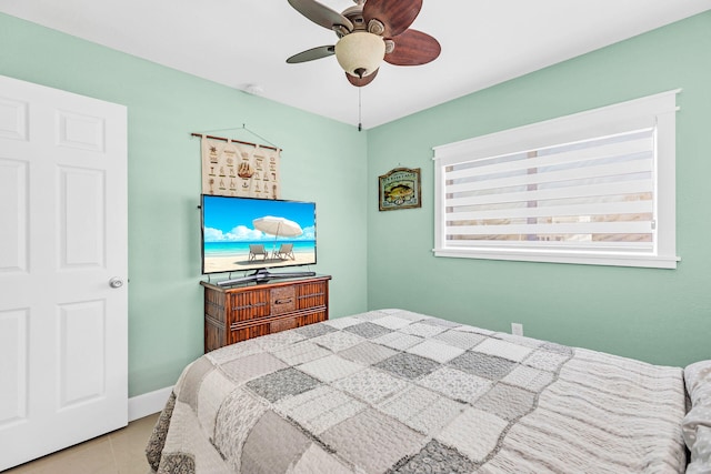 tiled bedroom featuring ceiling fan