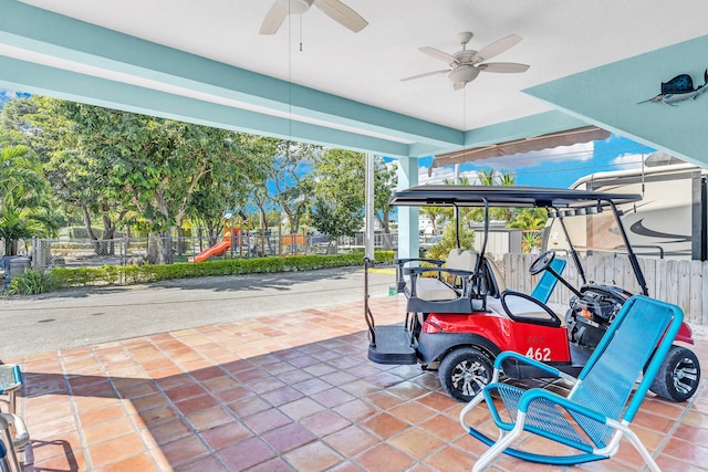 view of patio / terrace with ceiling fan and a playground